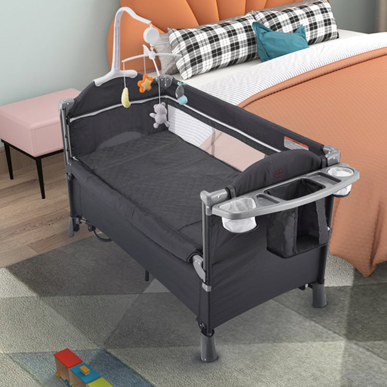 Crib beside outlet bed